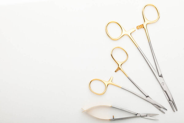 Steel surgical tools and laboratory equipment isolated on a white background. Professional clinic instruments. Medical, surgery, ambulance and veterinarian concept. Closeup with soft selective focus