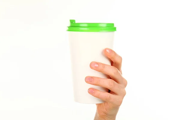 Human hand holds a blank paper Coffee cup with plastic cap. Concept of tea or coffee to go in a disposable mug. Mockup with copy space and place for text or logo. Isolated on a white background