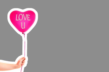 Kadın eli kırmızı kauçuk, şişme kalp şeklinde balon tutuyor. Aşk, ilişki, sevgililer günü ve doğum günü kutlaması konsepti. Boş kopya alanı olan dergi tarzı moda kolajı