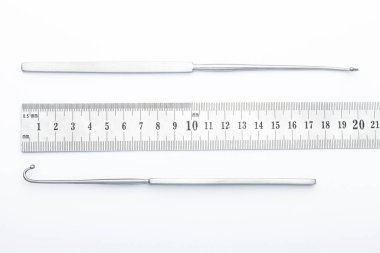 Çelik cerrahi aletler ve laboratuvar ekipmanları beyaz arka planda izole edilmiş. Profesyonel klinik aletleri. Tıbbi, cerrahi, ambulans ve veteriner konsepti. Yumuşak seçici odaklı yakın plan