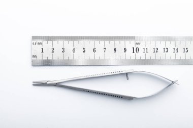 Çelik cerrahi aletler ve laboratuvar ekipmanları beyaz arka planda izole edilmiş. Profesyonel klinik aletleri. Tıbbi, cerrahi, ambulans ve veteriner konsepti. Yumuşak seçici odaklı yakın plan