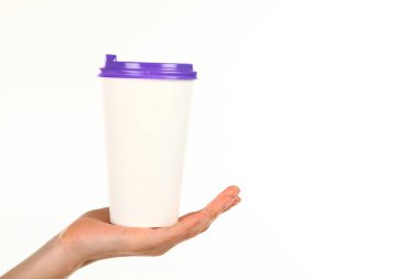 İnsan eli plastik kapaklı boş bir kahve fincanı tutar. Tek kullanımlık fincana çay ya da kahve konsepti. Metin veya logo için yeri ve yeri kopyala. Beyaz bir arkaplanda izole edilmiş