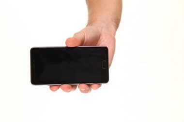 İnsan eli, avucunda boş bir krom ekran olan modern bir akıllı telefonu tutar. Teknoloji ve reklam kavramı. Ayrıntılı yakın çekim stüdyo çekimi soyut beyaz arka planda izole