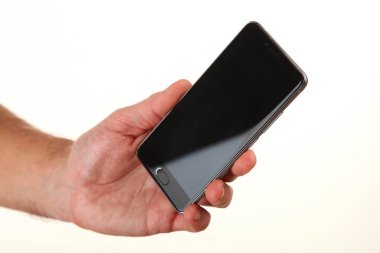 İnsan eli, avucunda boş bir krom ekran olan modern bir akıllı telefonu tutar. Teknoloji ve reklam kavramı. Ayrıntılı yakın çekim stüdyo çekimi soyut beyaz arka planda izole