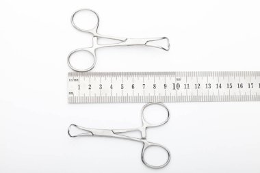 Çelik cerrahi aletler ve laboratuvar ekipmanları beyaz arka planda izole edilmiş. Profesyonel klinik aletleri. Tıbbi, cerrahi, ambulans ve veteriner konsepti. Yumuşak seçici odaklı yakın plan