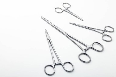 Çelik cerrahi aletler ve laboratuvar ekipmanları beyaz arka planda izole edilmiş. Profesyonel klinik aletleri. Tıbbi, cerrahi, ambulans ve veteriner konsepti. Yumuşak seçici odaklı yakın plan