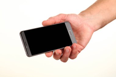 İnsan eli, avucunda boş bir krom ekran olan modern bir akıllı telefonu tutar. Teknoloji ve reklam kavramı. Ayrıntılı yakın çekim stüdyo çekimi soyut beyaz arka planda izole