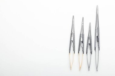 Çelik cerrahi aletler ve laboratuvar ekipmanları beyaz arka planda izole edilmiş. Profesyonel klinik aletleri. Tıbbi, cerrahi, ambulans ve veteriner konsepti. Yumuşak seçici odaklı yakın plan