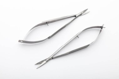 Çelik cerrahi aletler ve laboratuvar ekipmanları beyaz arka planda izole edilmiş. Profesyonel klinik aletleri. Tıbbi, cerrahi, ambulans ve veteriner konsepti. Yumuşak seçici odaklı yakın plan