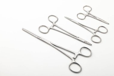 Çelik cerrahi aletler ve laboratuvar ekipmanları beyaz arka planda izole edilmiş. Profesyonel klinik aletleri. Tıbbi, cerrahi, ambulans ve veteriner konsepti. Yumuşak seçici odaklı yakın plan