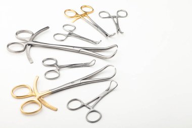 Çelik cerrahi aletler ve laboratuvar ekipmanları beyaz arka planda izole edilmiş. Profesyonel klinik aletleri. Tıbbi, cerrahi, ambulans ve veteriner konsepti. Yumuşak seçici odaklı yakın plan