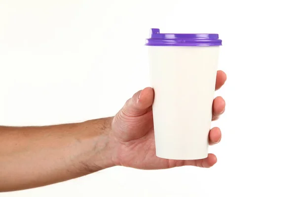 stock image Human hand holds a blank paper Coffee cup with plastic cap. Concept of tea or coffee to go in a disposable mug. Mockup with copy space and place for text or logo. Isolated on a white background