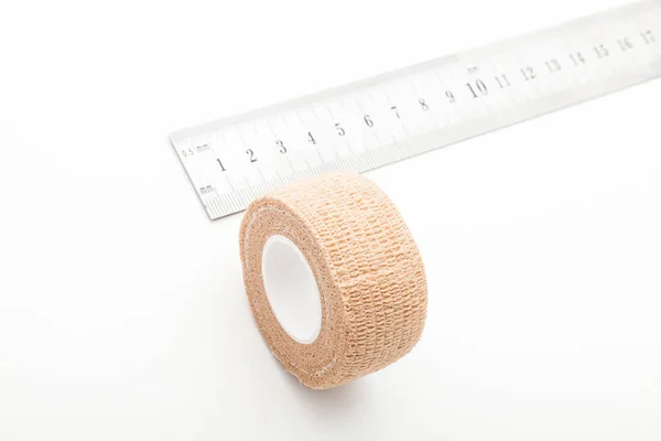 Flexible bandage and laboratory equipment isolated on a white background. Professional clinic instruments. Medical, surgery, ambulance and veterinarian concept. Closeup with soft selective focus