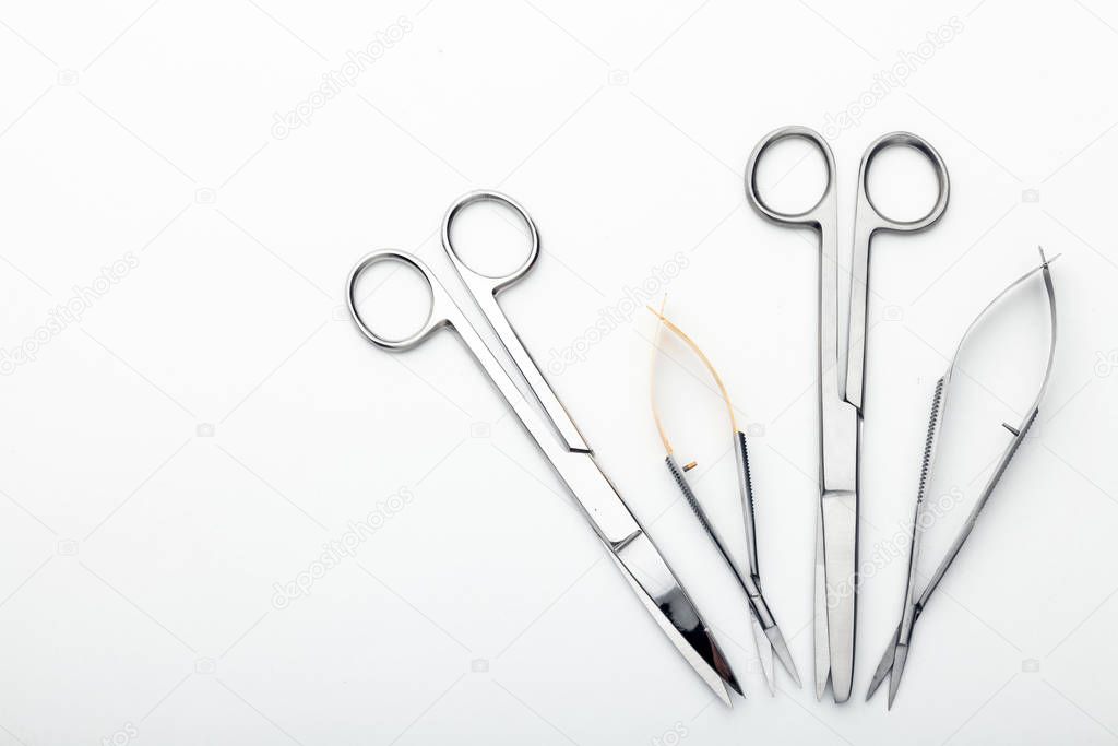 Steel surgical tools and laboratory equipment isolated on a white background. Professional clinic instruments. Medical, surgery, ambulance and veterinarian concept. Closeup with soft selective focus