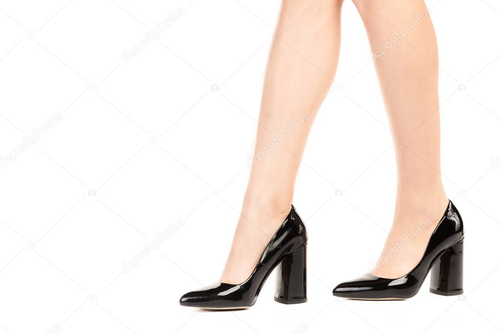 Ladies outfit footwear. Long slim female's legs wearing high heels shoes. Fashion mockup with copy space. Classic and casual clothes concept. Detailed closeup studio shot isolated on white background.