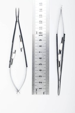 Çelik cerrahi aletler ve laboratuvar ekipmanları beyaz arka planda izole edilmiş. Profesyonel klinik aletleri. Tıbbi, cerrahi, ambulans ve veteriner konsepti. Yumuşak seçici odaklı yakın plan