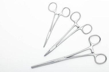 Çelik cerrahi aletler ve laboratuvar ekipmanları beyaz arka planda izole edilmiş. Profesyonel klinik aletleri. Tıbbi, cerrahi, ambulans ve veteriner konsepti. Yumuşak seçici odaklı yakın plan