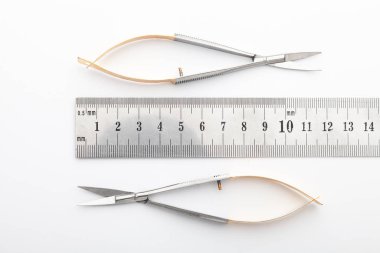 Çelik cerrahi aletler ve laboratuvar ekipmanları beyaz arka planda izole edilmiş. Profesyonel klinik aletleri. Tıbbi, cerrahi, ambulans ve veteriner konsepti. Yumuşak seçici odaklı yakın plan