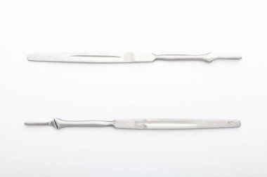 Çelik cerrahi aletler ve laboratuvar ekipmanları beyaz arka planda izole edilmiş. Profesyonel klinik aletleri. Tıbbi, cerrahi, ambulans ve veteriner konsepti. Yumuşak seçici odaklı yakın plan