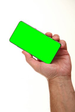 İnsan eli, avucunda boş bir krom ekran olan modern bir akıllı telefonu tutar. Teknoloji ve reklam kavramı. Ayrıntılı yakın çekim stüdyo çekimi soyut beyaz arka planda izole