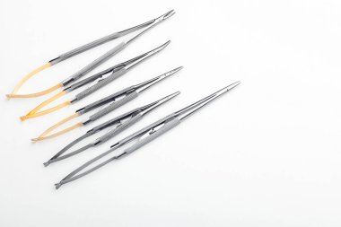 Çelik cerrahi aletler ve laboratuvar ekipmanları beyaz arka planda izole edilmiş. Profesyonel klinik aletleri. Tıbbi, cerrahi, ambulans ve veteriner konsepti. Yumuşak seçici odaklı yakın plan