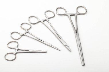 Çelik cerrahi aletler ve laboratuvar ekipmanları beyaz arka planda izole edilmiş. Profesyonel klinik aletleri. Tıbbi, cerrahi, ambulans ve veteriner konsepti. Yumuşak seçici odaklı yakın plan
