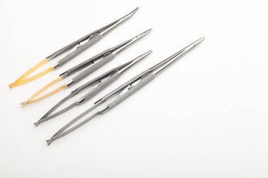 Çelik cerrahi aletler ve laboratuvar ekipmanları beyaz arka planda izole edilmiş. Profesyonel klinik aletleri. Tıbbi, cerrahi, ambulans ve veteriner konsepti. Yumuşak seçici odaklı yakın plan