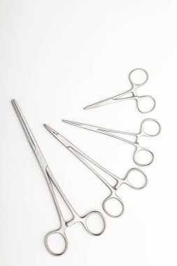 Çelik cerrahi aletler ve laboratuvar ekipmanları beyaz arka planda izole edilmiş. Profesyonel klinik aletleri. Tıbbi, cerrahi, ambulans ve veteriner konsepti. Yumuşak seçici odaklı yakın plan