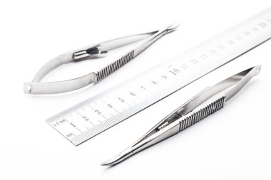 Çelik cerrahi aletler ve laboratuvar ekipmanları beyaz arka planda izole edilmiş. Profesyonel klinik aletleri. Tıbbi, cerrahi, ambulans ve veteriner konsepti. Yumuşak seçici odaklı yakın plan