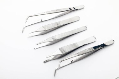 Çelik cerrahi aletler ve laboratuvar ekipmanları beyaz arka planda izole edilmiş. Profesyonel klinik aletleri. Tıbbi, cerrahi, ambulans ve veteriner konsepti. Yumuşak seçici odaklı yakın plan