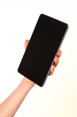 İnsan eli, avucunda boş bir krom ekran olan modern bir akıllı telefonu tutar. Teknoloji ve reklam kavramı. Ayrıntılı yakın çekim stüdyo çekimi soyut beyaz arka planda izole