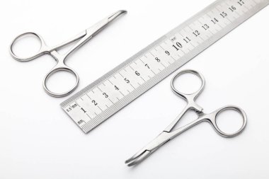 Çelik cerrahi aletler ve laboratuvar ekipmanları beyaz arka planda izole edilmiş. Profesyonel klinik aletleri. Tıbbi, cerrahi, ambulans ve veteriner konsepti. Yumuşak seçici odaklı yakın plan