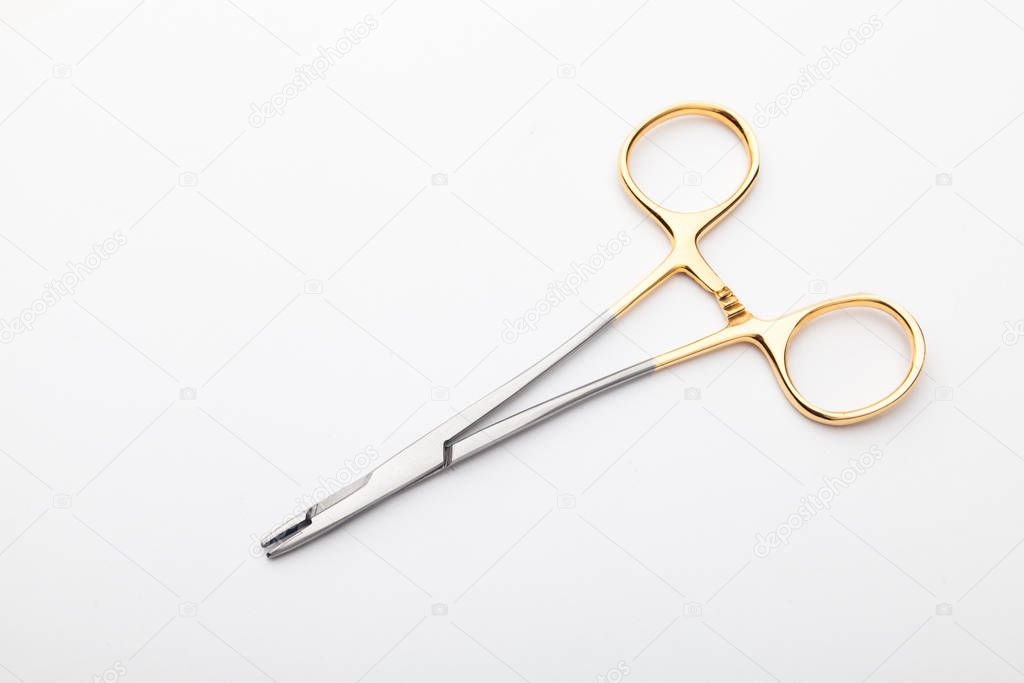 Steel surgical tools and laboratory equipment isolated on a white background. Professional clinic instruments. Medical, surgery, ambulance and veterinarian concept. Closeup with soft selective focus