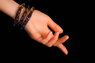 Güzel bir el yapımı mücevher bileziği. Renkli parlak boncuklar ve nötr manikürlü gevşek bir kadın bileği. Moda ve el işi aksesuarları. Yumuşak seçici odaklı yakın plan