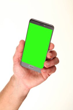 İnsan eli, avucunda boş bir krom ekran olan modern bir akıllı telefonu tutar. Teknoloji ve reklam kavramı. Ayrıntılı yakın çekim stüdyo çekimi soyut beyaz arka planda izole