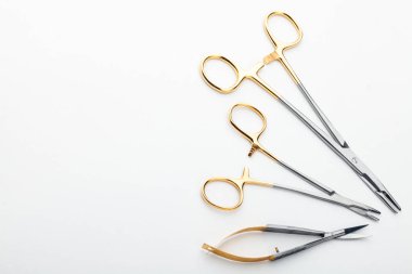 Çelik cerrahi aletler ve laboratuvar ekipmanları beyaz arka planda izole edilmiş. Profesyonel klinik aletleri. Tıbbi, cerrahi, ambulans ve veteriner konsepti. Yumuşak seçici odaklı yakın plan