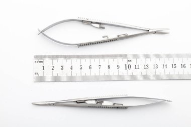 Çelik cerrahi aletler ve laboratuvar ekipmanları beyaz arka planda izole edilmiş. Profesyonel klinik aletleri. Tıbbi, cerrahi, ambulans ve veteriner konsepti. Yumuşak seçici odaklı yakın plan