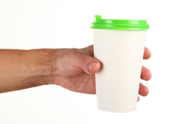 İnsan eli plastik kapaklı boş bir kahve fincanı tutar. Tek kullanımlık fincana çay ya da kahve konsepti. Metin veya logo için yeri ve yeri kopyala. Beyaz bir arkaplanda izole edilmiş