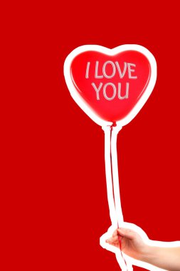 Kadın eli kırmızı kauçuk, şişme kalp şeklinde balon tutuyor. Aşk, ilişki, sevgililer günü ve doğum günü kutlaması konsepti. Boş kopya alanı olan dergi tarzı moda kolajı