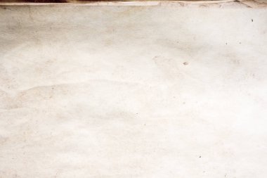 Eski kağıt çarşaf. Toz ve kirli lekelerle dolu boş bir arka plan. Eski ve antika sanat konsepti. Ayrıntılı yakın çekim stüdyo çekimi. Ön manzara. Ayarlanmış