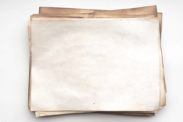 Aged paper sheet. Blank old background with dust and dirty stains. Vintage and antique art concept. Detailed closeup studio shot. Front view. Toned