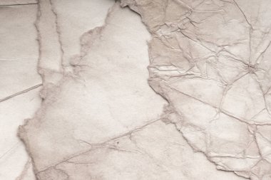 Eski kağıt çarşaf. Toz ve kirli lekelerle dolu boş bir arka plan. Eski ve antika sanat konsepti. Ayrıntılı yakın çekim stüdyo çekimi. Ön manzara. Ayarlanmış