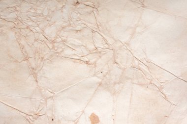 Aged paper sheet. Blank old background with dust and dirty stains. Vintage and antique art concept. Poster mockup. Detailed closeup studio shot. Front view. Toned