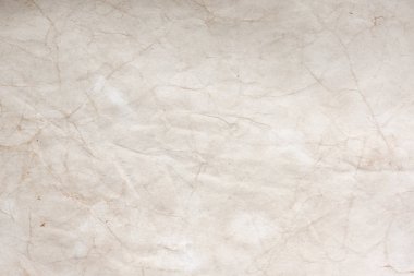 Aged paper sheet. Blank old background with dust and dirty stains. Vintage and antique art concept. Poster mockup. Detailed closeup studio shot. Front view. Toned