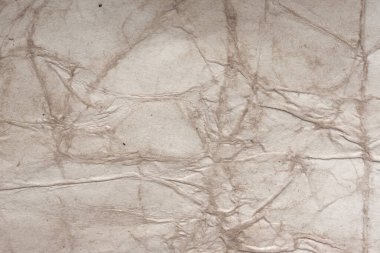 Aged paper sheet. Blank old background with dust and dirty stains. Vintage and antique art concept. Poster mockup. Detailed closeup studio shot. Front view. Toned