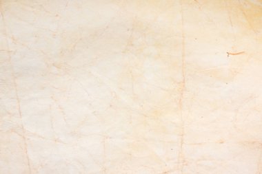 Aged paper sheet. Blank old background with dust and dirty stains. Vintage and antique art concept. Poster mockup. Detailed closeup studio shot. Front view. Toned