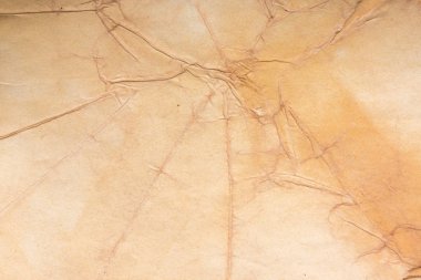 Aged paper sheet. Blank old background with dust and dirty stains. Vintage and antique art concept. Poster mockup. Detailed closeup studio shot. Front view. Toned