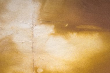 Aged paper sheet. Blank old background with dust and dirty stains. Vintage and antique art concept. Poster mockup. Detailed closeup studio shot. Front view. Toned