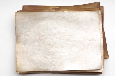 Aged paper sheet. Blank old background with dust and dirty stains. Vintage and antique art concept. Poster mockup. Detailed closeup studio shot. Front view. Toned