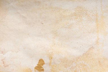 Aged paper sheet. Blank old background with dust and dirty stains. Vintage and antique art concept. Poster mockup. Detailed closeup studio shot. Front view. Toned